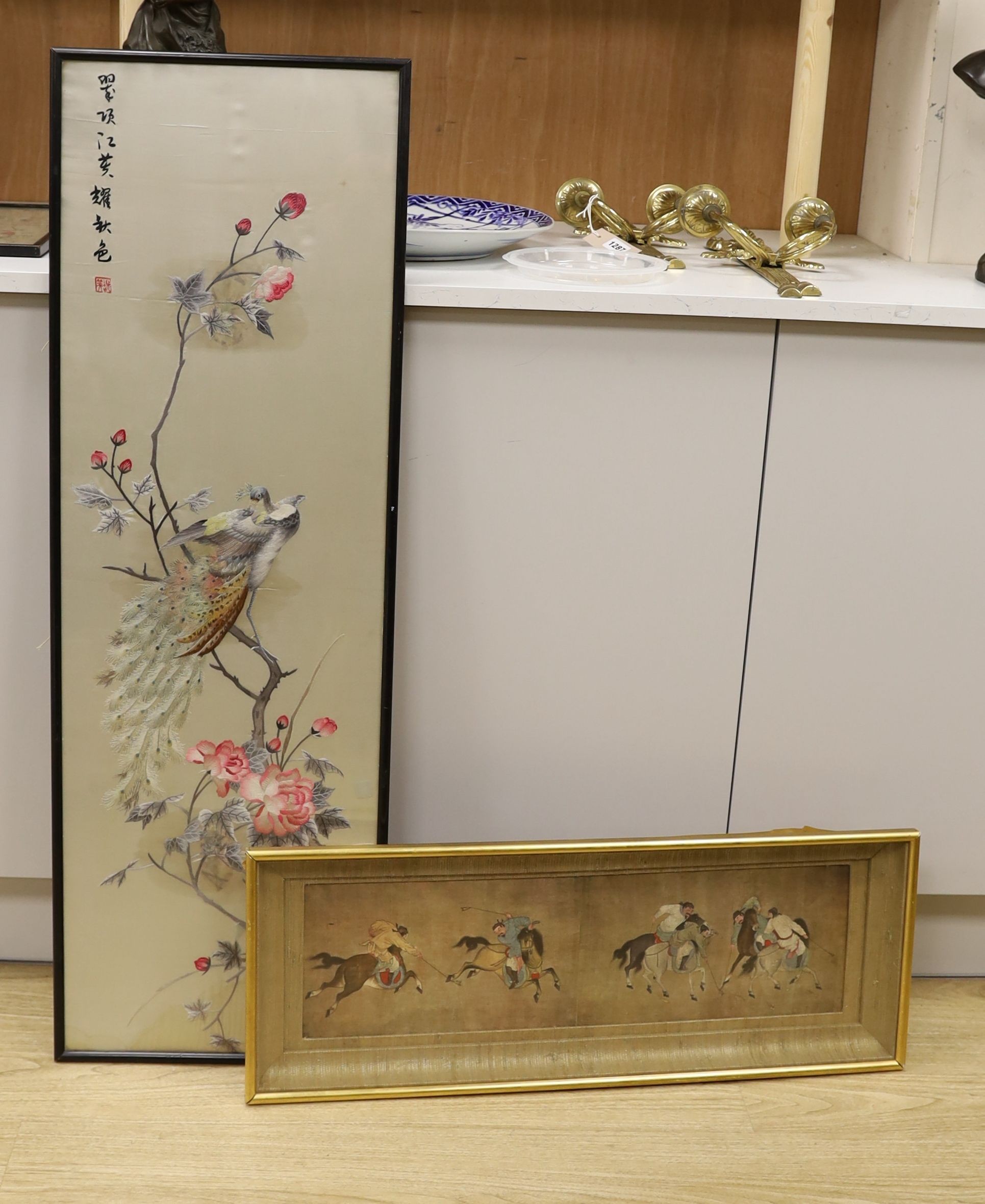 A Chinese silkwork panel of a peacock upon flowering branches, 112 x 35cm and a colour print of Chinese polo players
